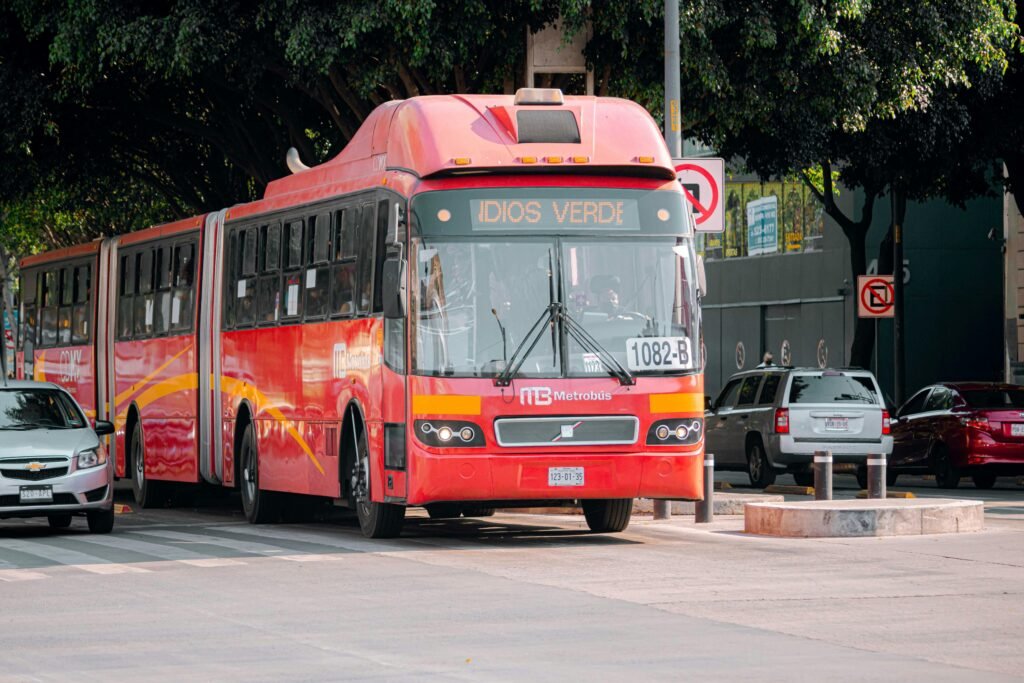 Red articulated Metrobús bus on a Mexico City street
